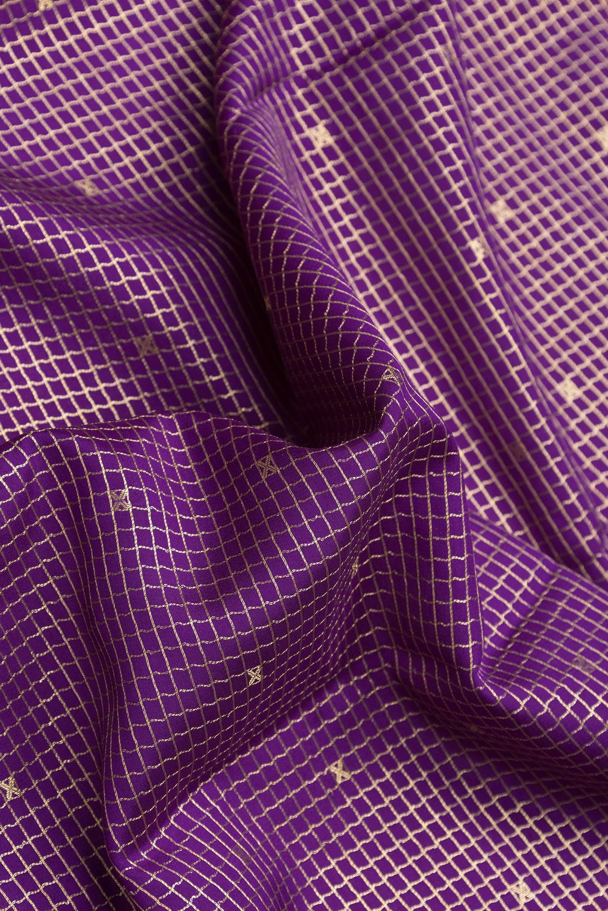 Close up of Violet Dual Tone Mysore Silk Saree with Checked design on the body and Zari Border.  displaying folds