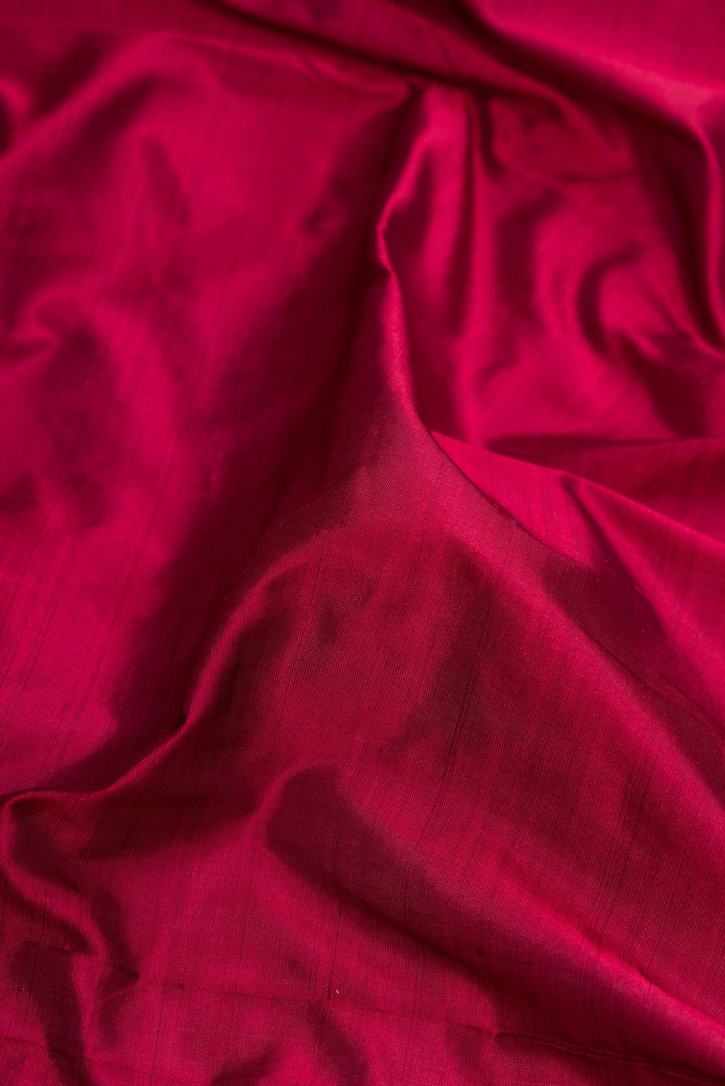 Close up of Maroon Dual Tone Kanjivaram Silk Nine Yards Saree with Plain Body and Zari Border.  displaying folds