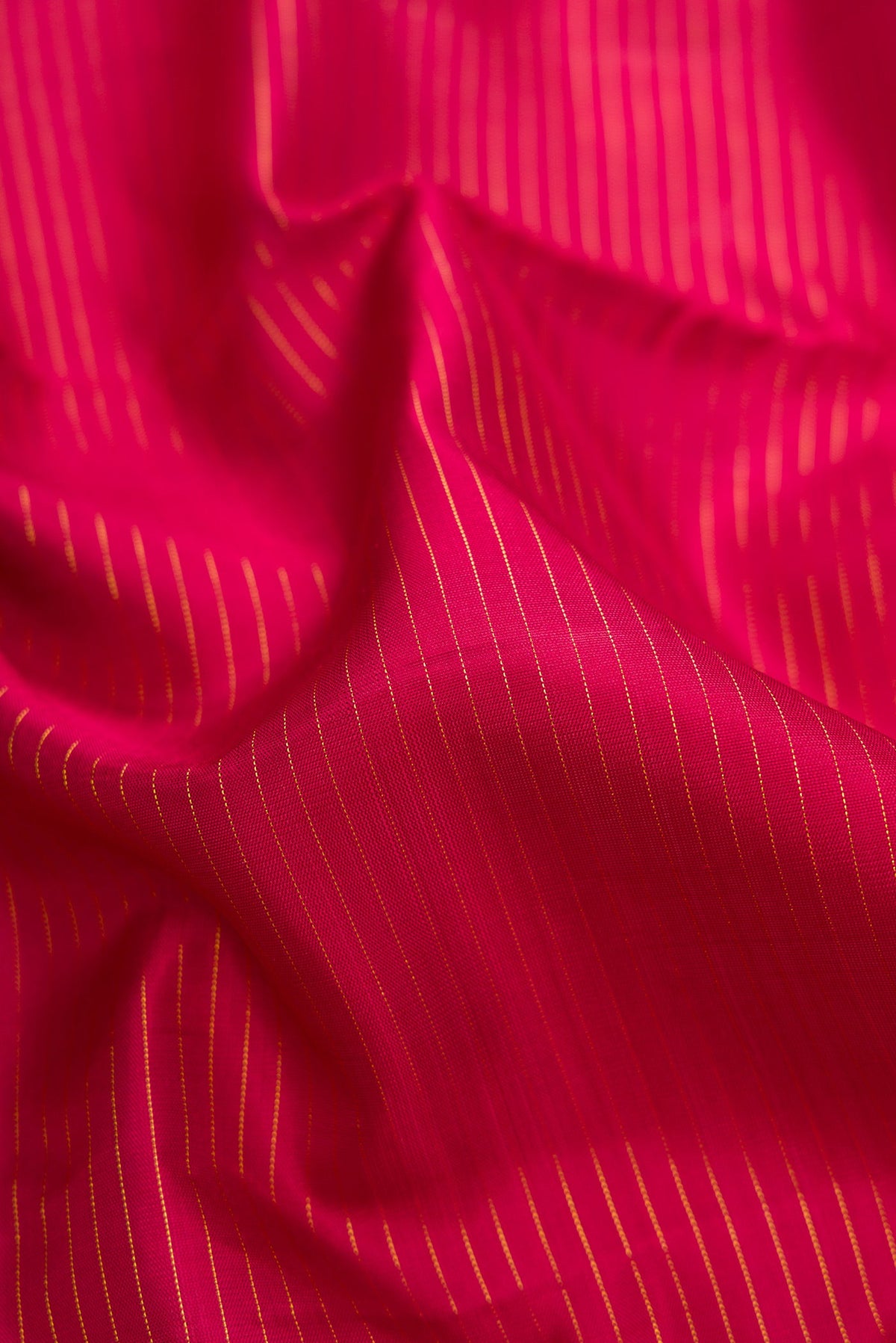 Close up of Pure Silk Pure Zari Maroon Dual Tone Kanjivaram Nine Yards Saree with Stripes on the body and Zari Border.  displaying folds