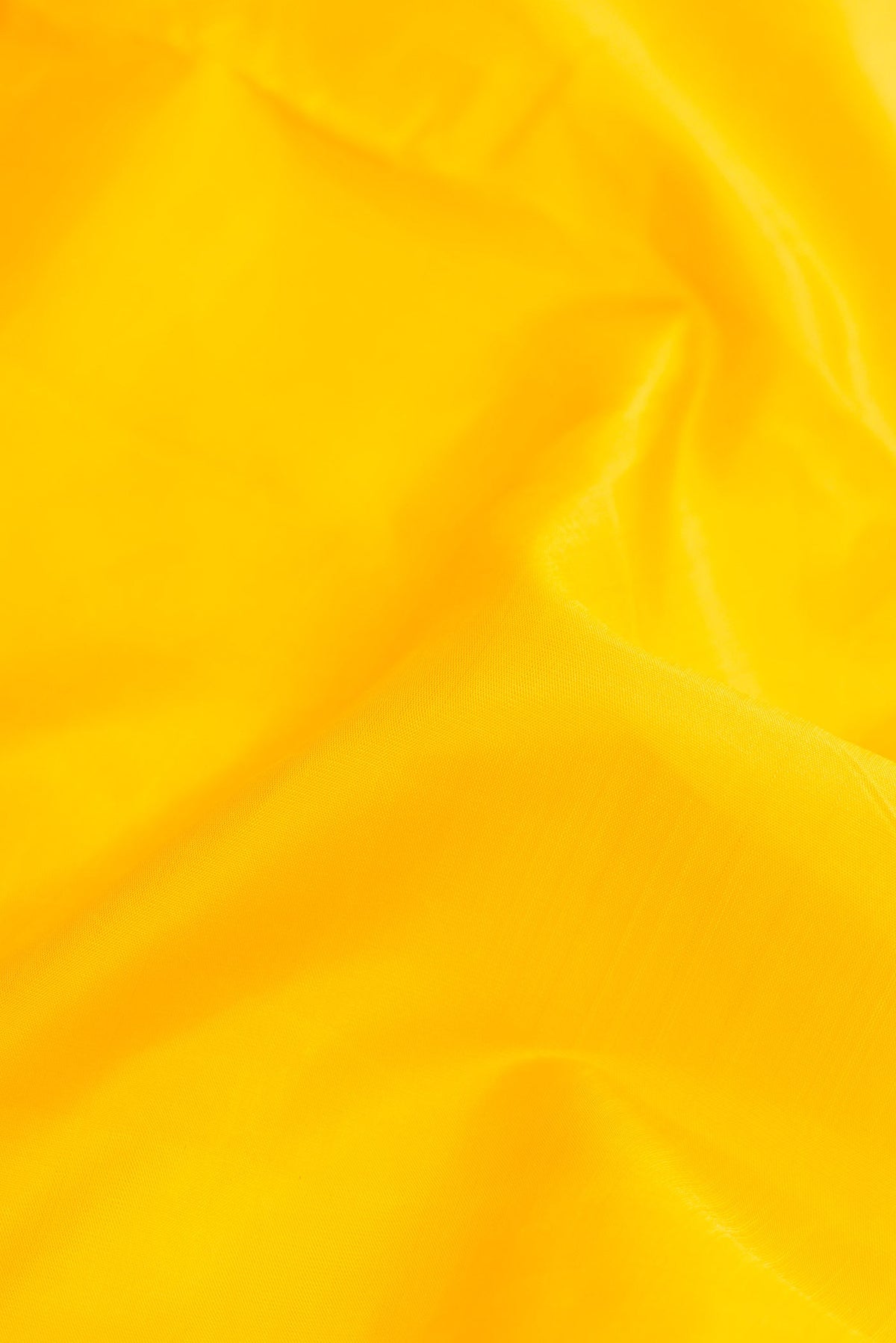 Close up of Pure Silk Pure Zari Yellow Dual Tone Kanchipuram Nine Yards Saree with Plain Body and Ganga Jamuna Border.  displaying folds
