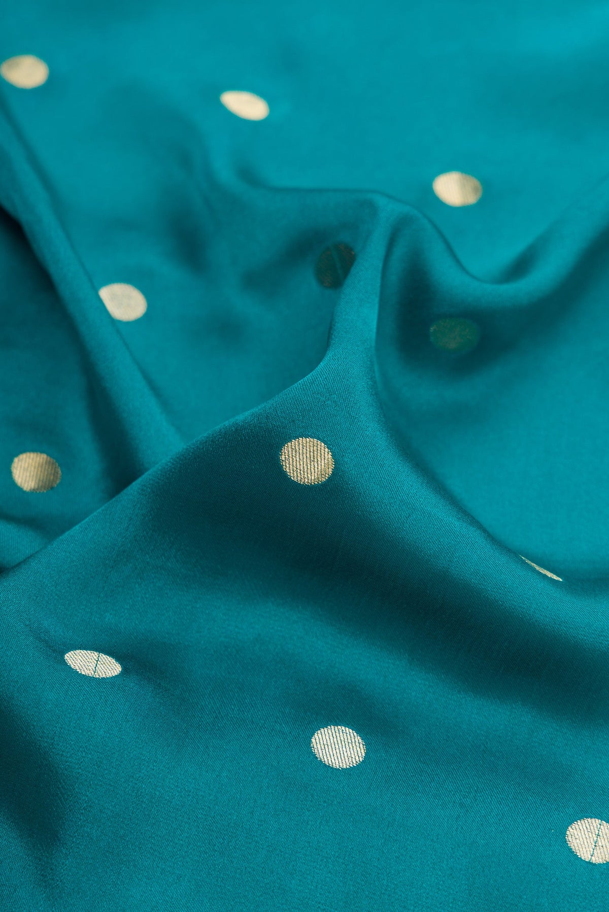 Close up of Peacock Blue Mysore Chiffon Saree with Zari Butta on the body and Zari Border.  displaying folds