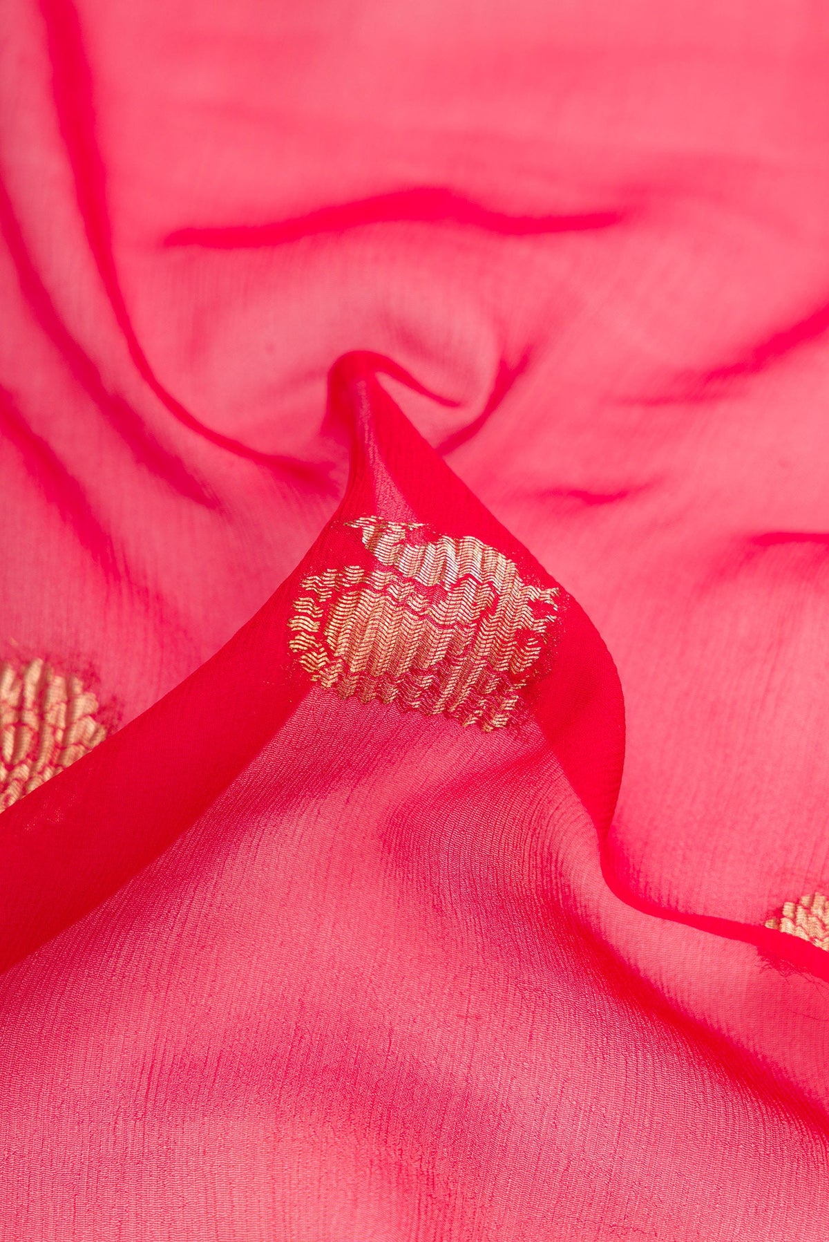 Close up of Red Dual Tone Mysore Georgette Saree with Zari Butta on the body and Plain Border.  displaying folds