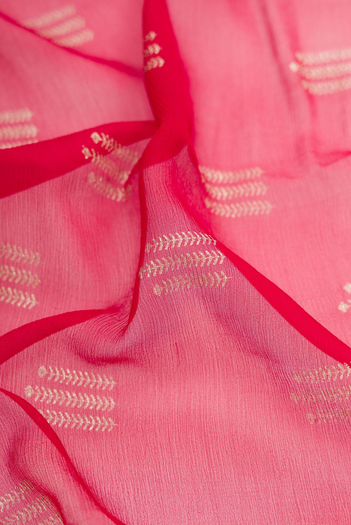 Close up of Red Mysore Chiffon Saree with Printed design on the body and Zari Border.  displaying folds