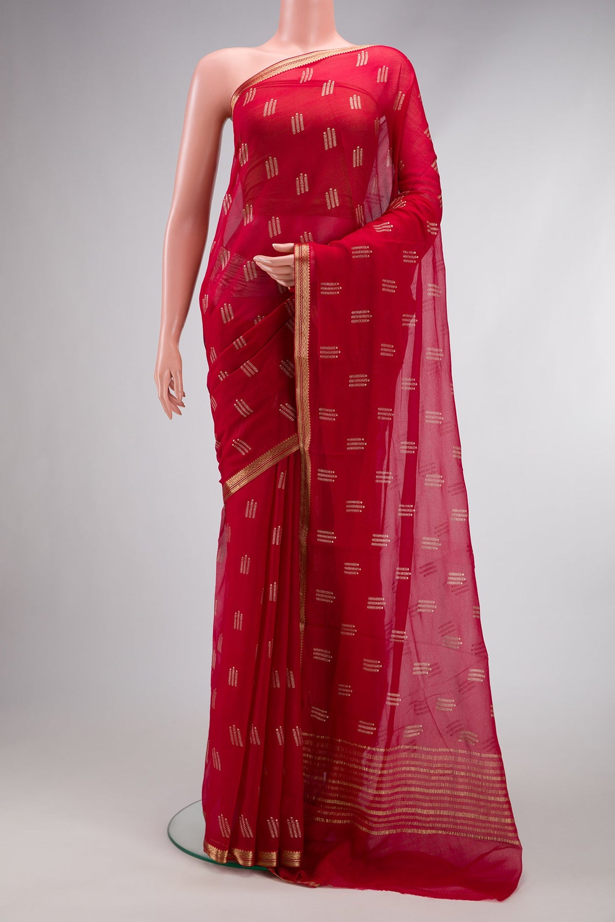 Red Mysore Chiffon Saree with Printed design on the body and Zari Border.  displayed on a mannequin