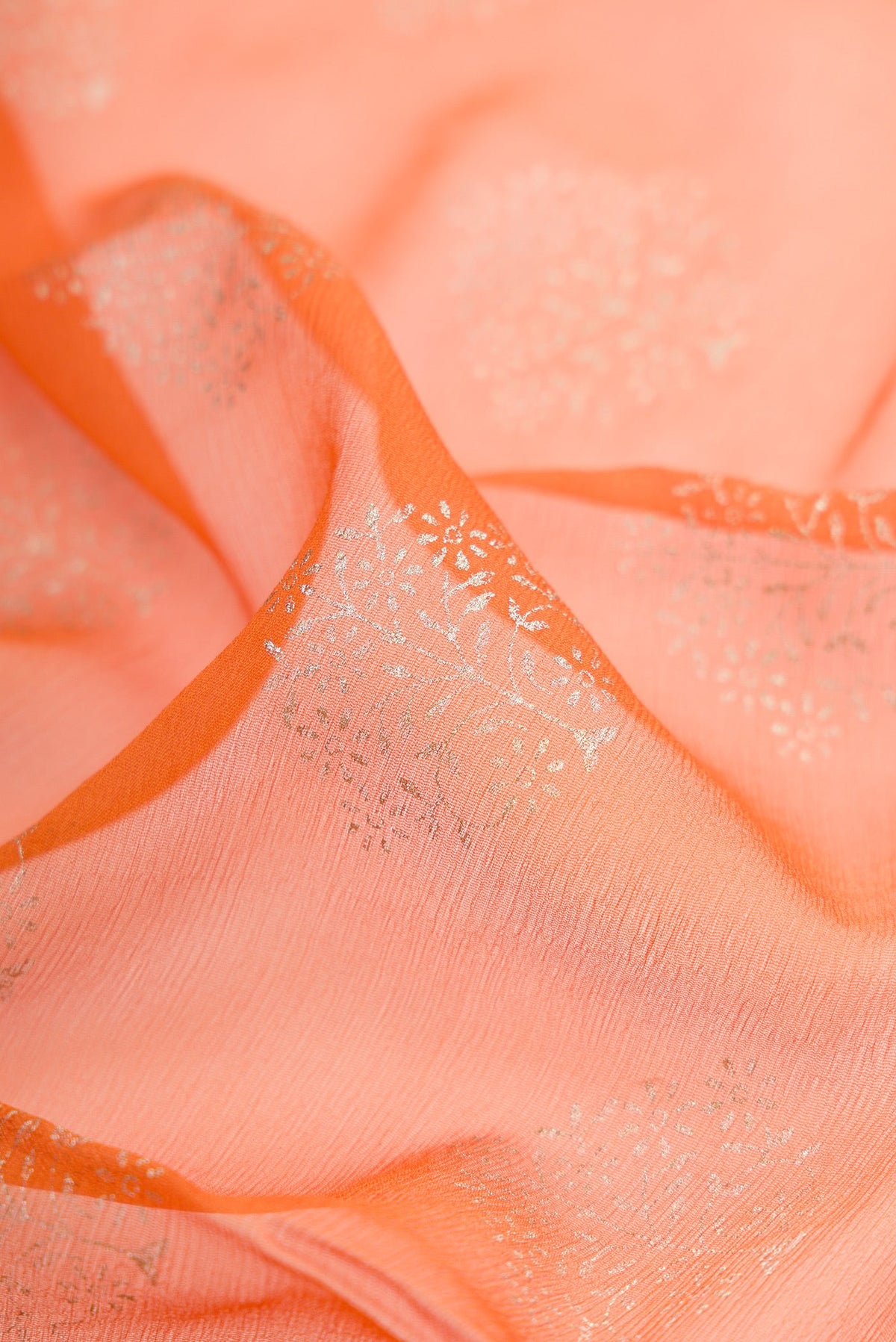 Close up of Mustard Mysore Chiffon Saree with Printed design on the body and Zari Border.  displaying folds