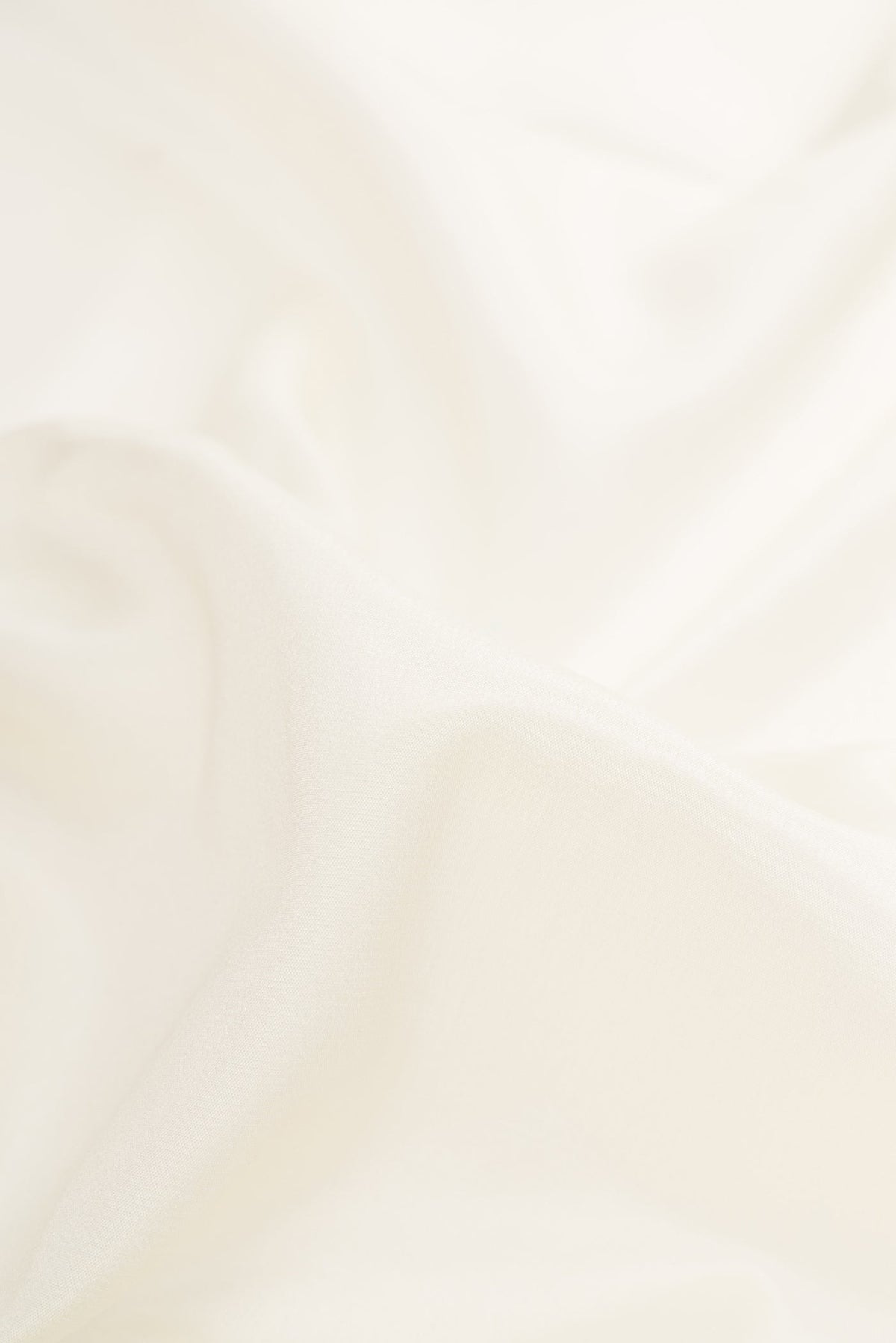 Close up of Off White Dual Tone Mysore Silk Saree with Plain Body and Zari Border.  displaying folds