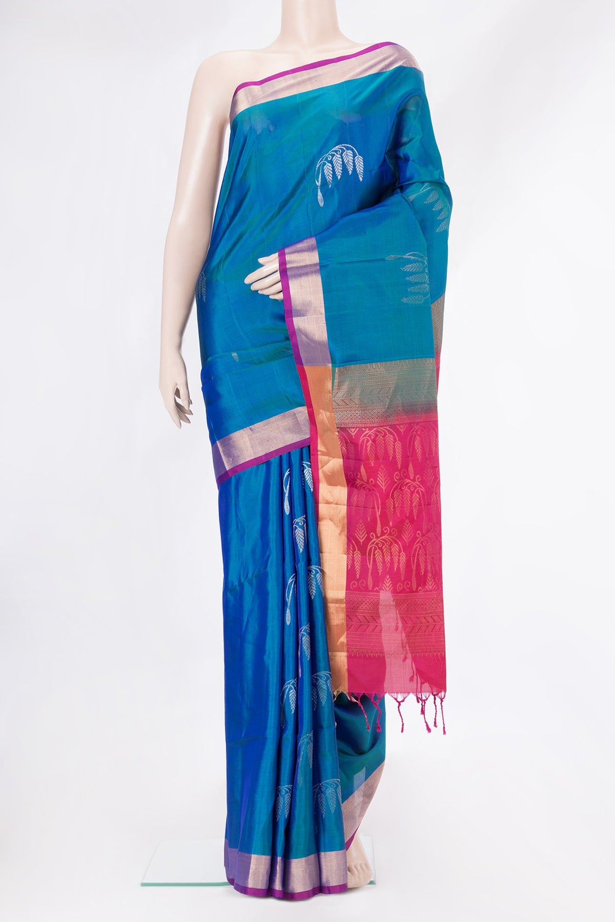 Peacock Blue Dual Tone Soft Silk Saree with Zari Butta on the body and Zari Border.  displayed on a mannequin