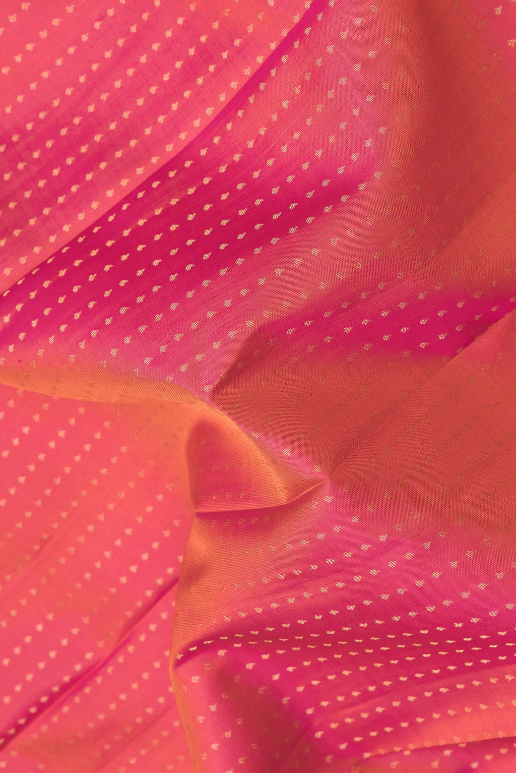 Close up of Pink Dual Tone Kanchipuram Silk Saree with Zari Butta on the body and Zari Border.  displaying folds