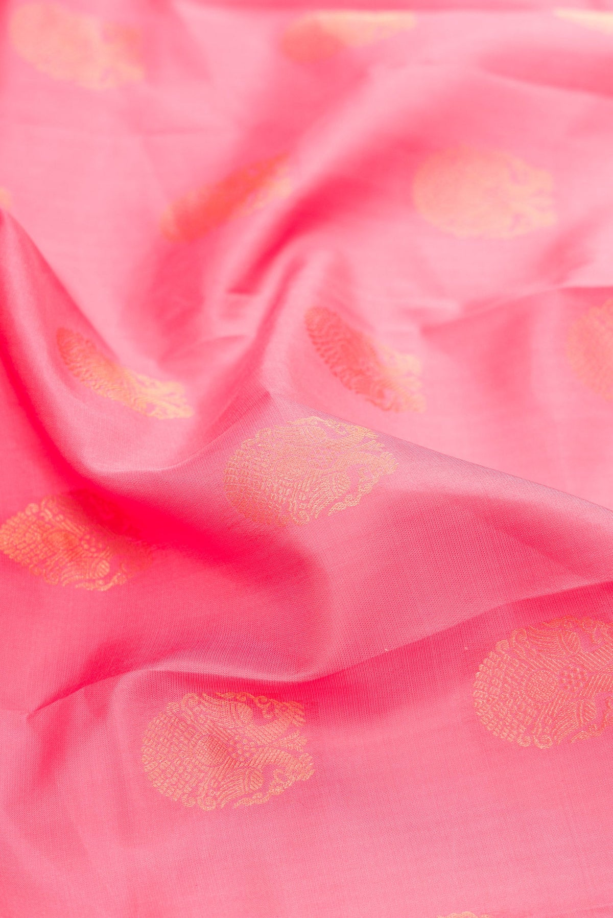 Close up of Pink Dual Tone Kanjivaram Silk Saree with Zari Butta on the body and Zari Border.  displaying folds