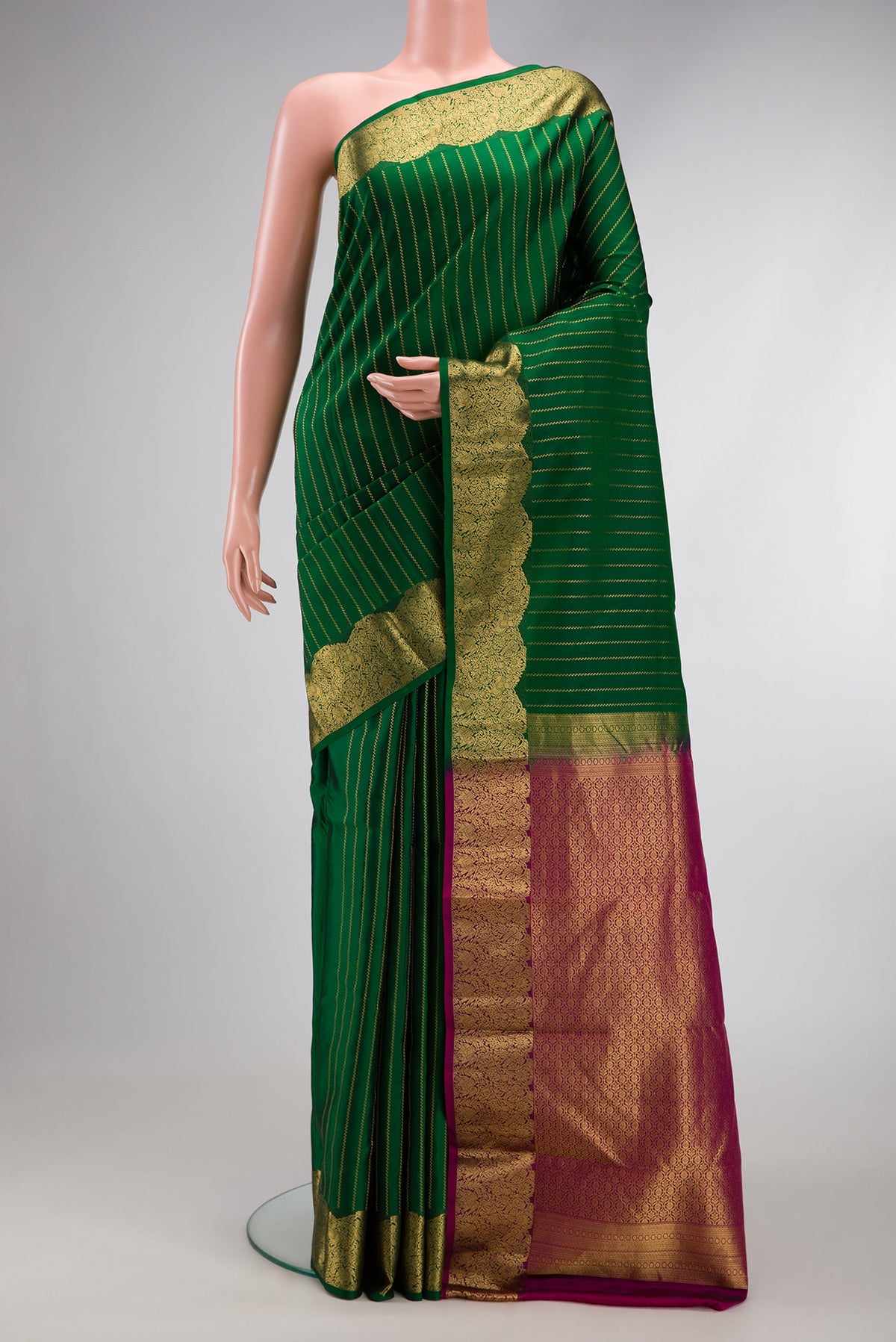 Bottle Green Dual Tone Kanchipuram Silk Saree with Stripes on the body and Fancy Border.  displayed on a mannequin
