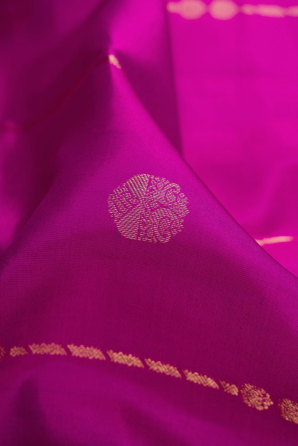 Close up of Purple Dual Tone Kanchipuram Silk Saree with Zari Butta on the body and Zari Border.  displaying folds