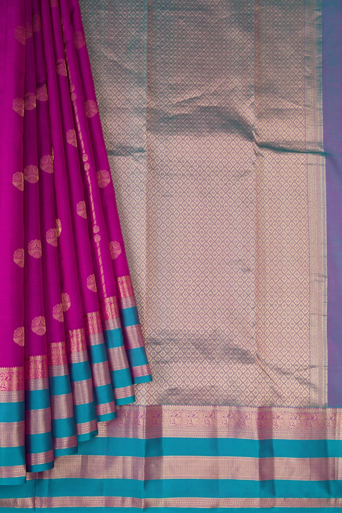 Pleats and pallu of Purple Dual Tone Kanchipuram Silk Saree with Zari Butta on the body and Zari Border. 