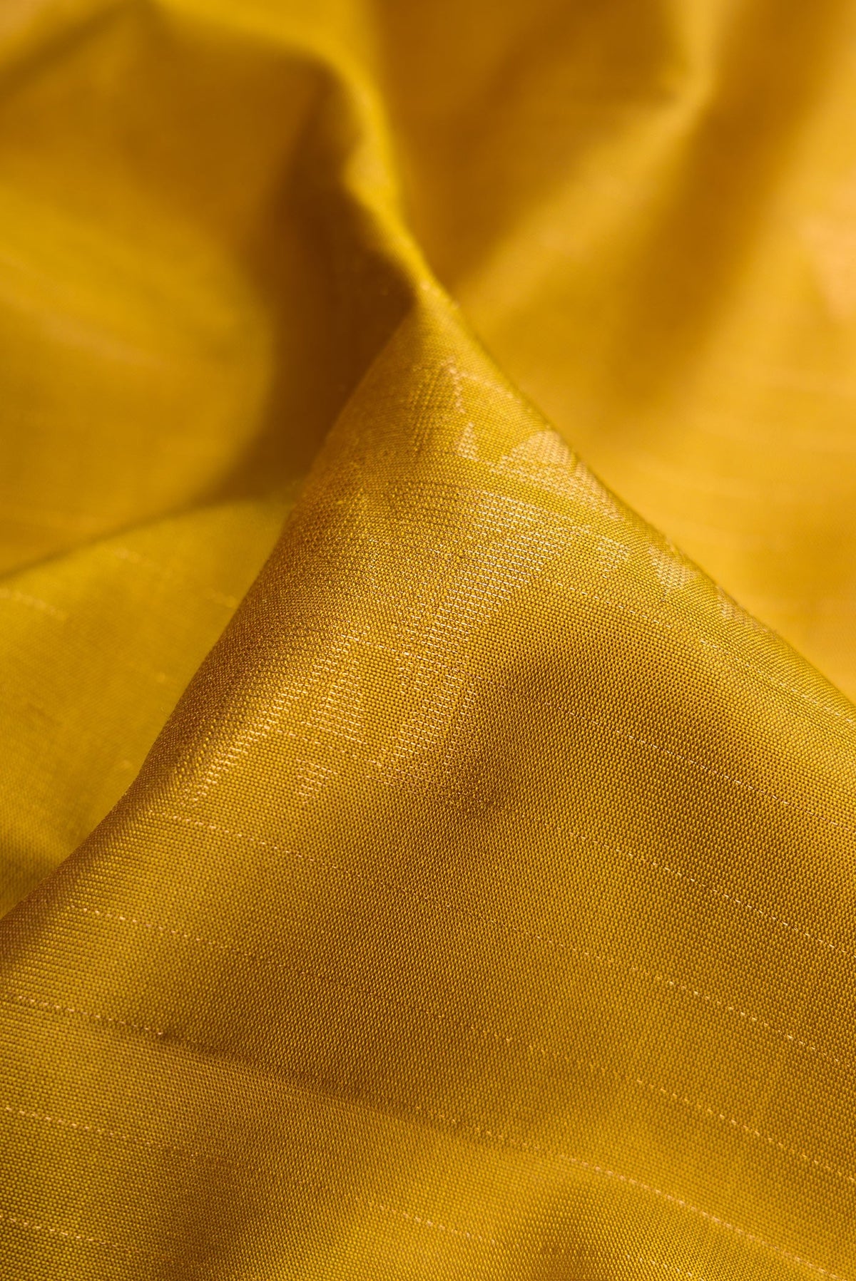 Close up of Mehandi Green Dual Tone Soft Silk Saree with Zari Butta on the body and Without Border.  displaying folds