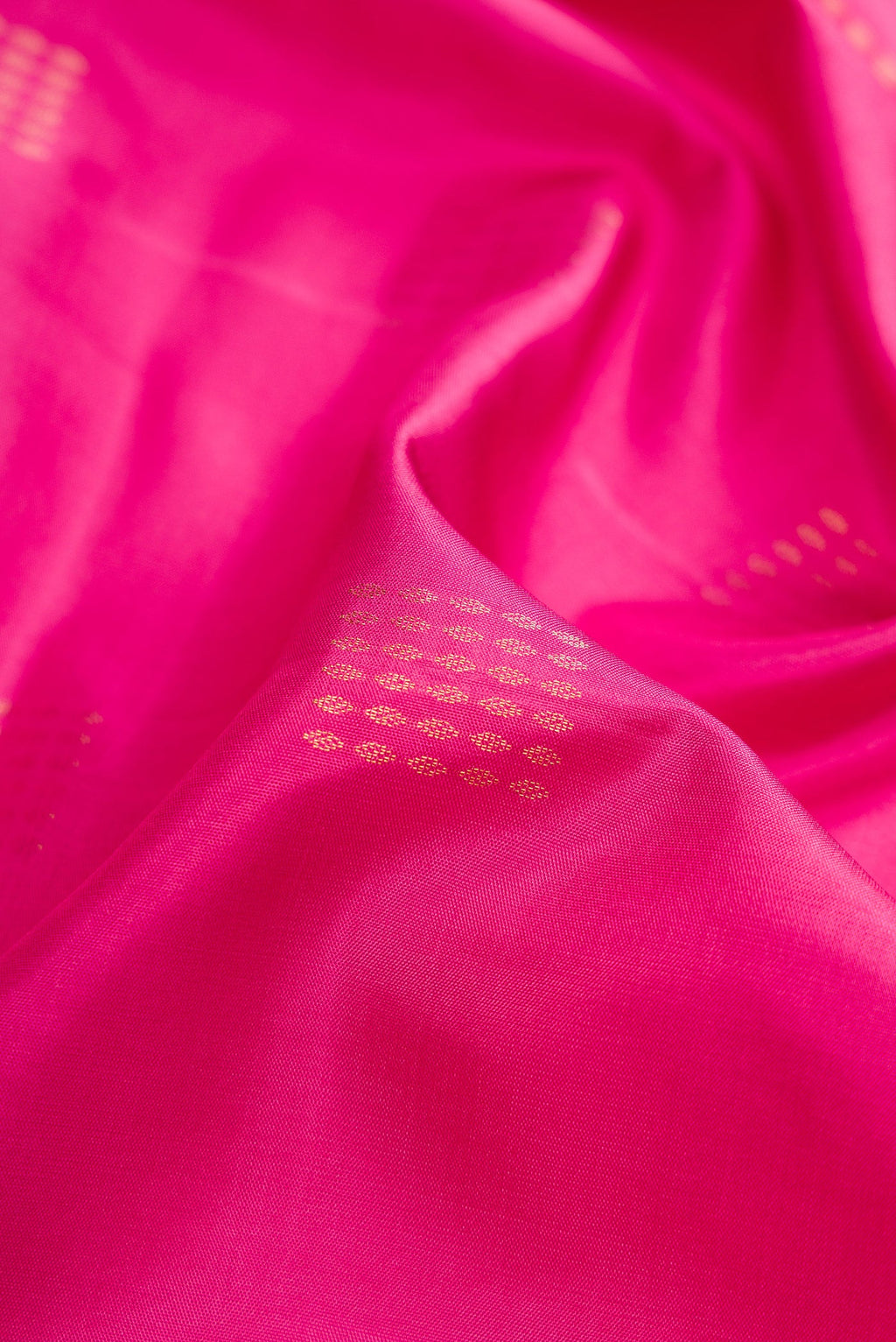Close up of Pink Dual Tone Soft Silk Saree with Zari Butta on the body and Fancy Border.  displaying folds