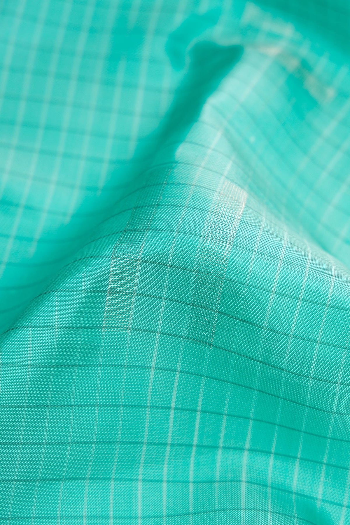 Close up of Sky Blue Dual Tone Soft Silk Saree with Stripes on the body and Without Border.  displaying folds