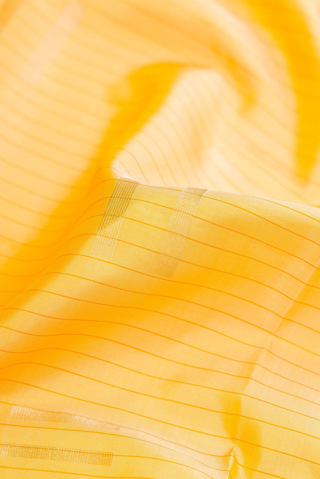 Close up of Sandal Dual Tone Soft Silk Saree with Stripes on the body and Without Border.  displaying folds
