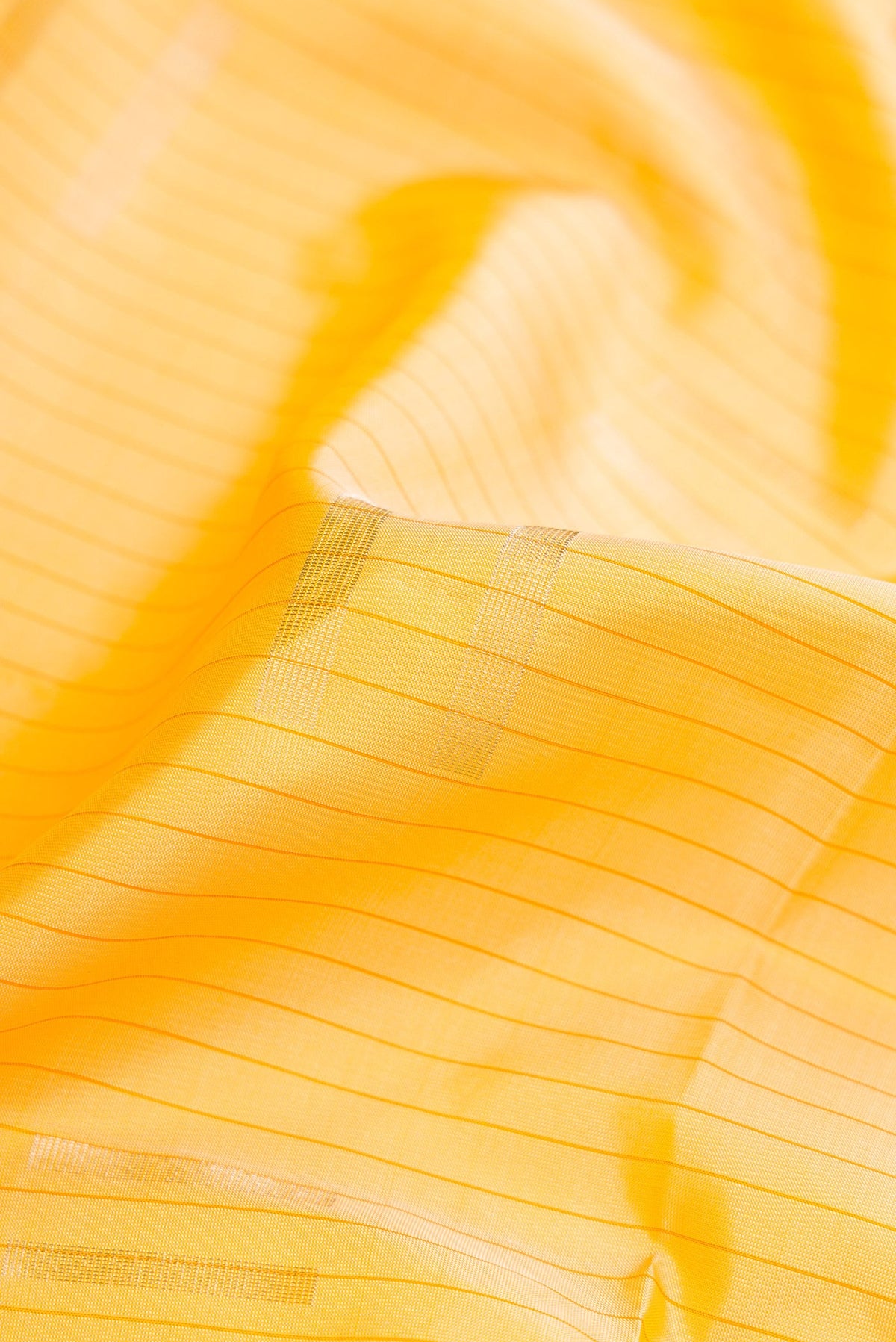 Close up of Sandal Dual Tone Soft Silk Saree with Stripes on the body and Without Border.  displaying folds