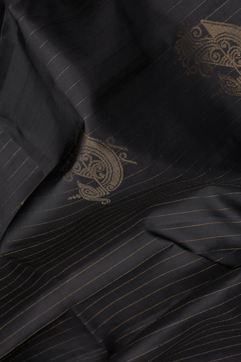 Close up of Black Soft Silk Saree with Stripes on the body and Without Border.  displaying folds