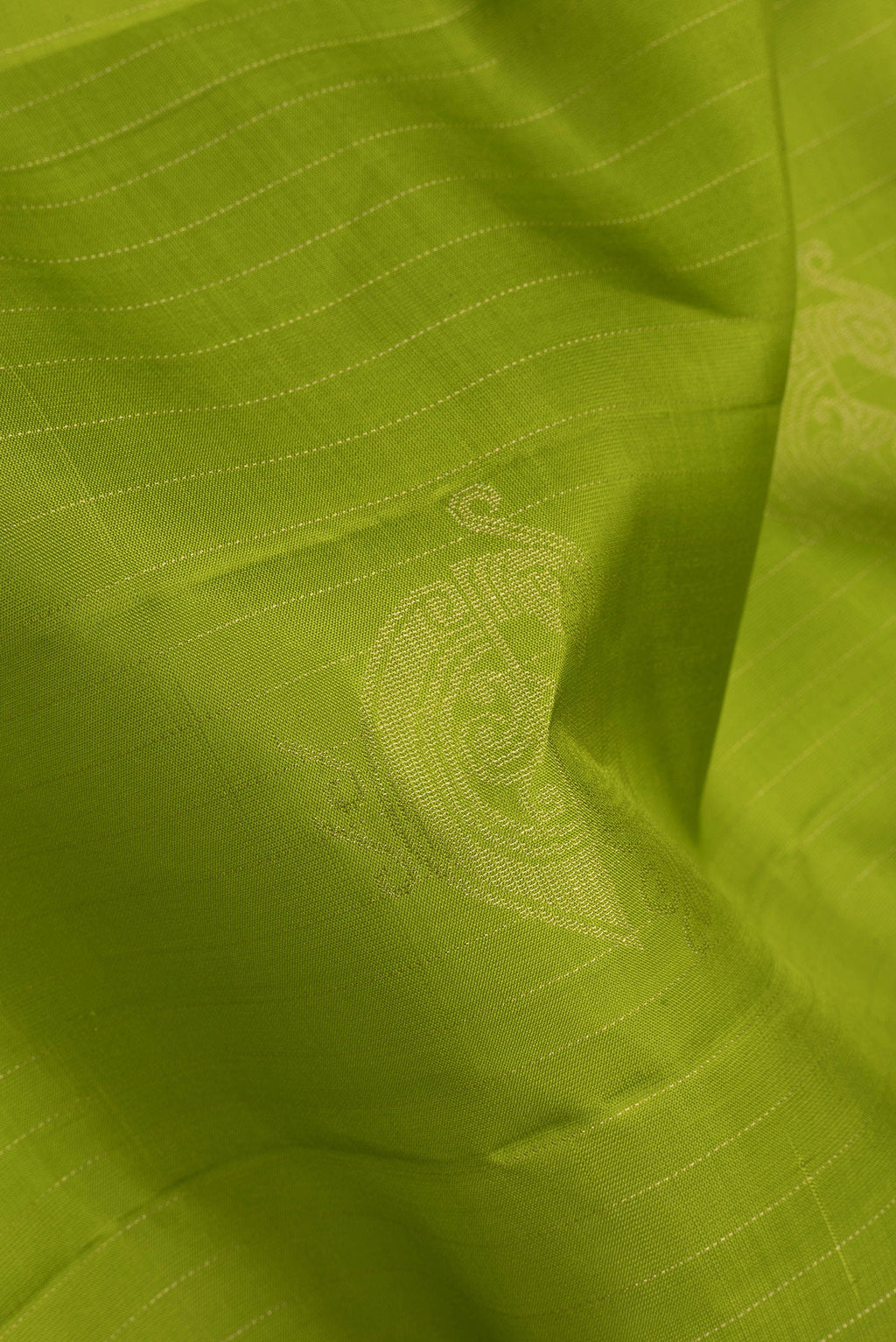 Close up of Green Soft Silk Saree with Stripes on the body and Without Border.  displaying folds