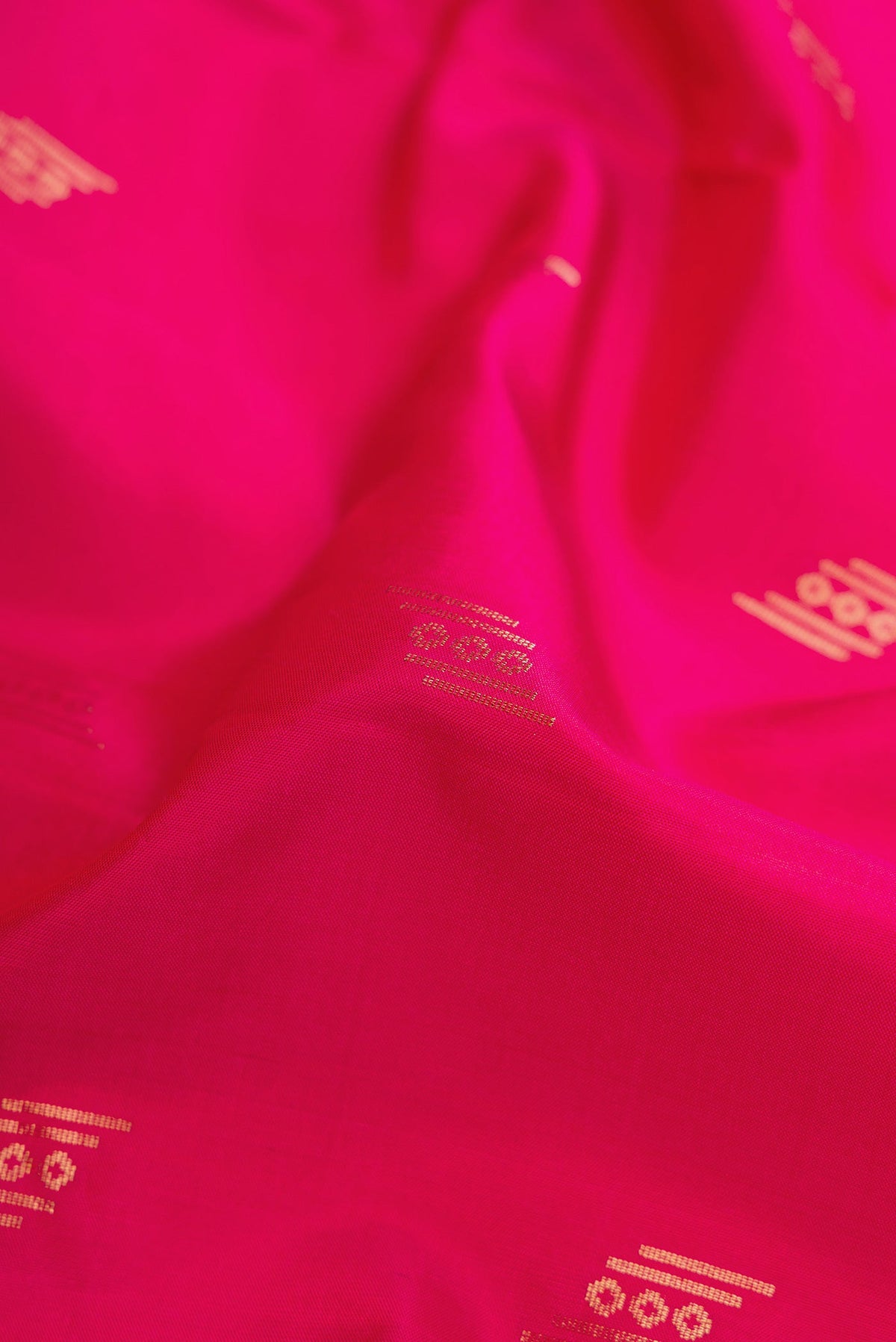 Close up of Dark Pink Dual Tone Soft Silk Saree with Zari Butta on the body and Zari Border.  displaying folds