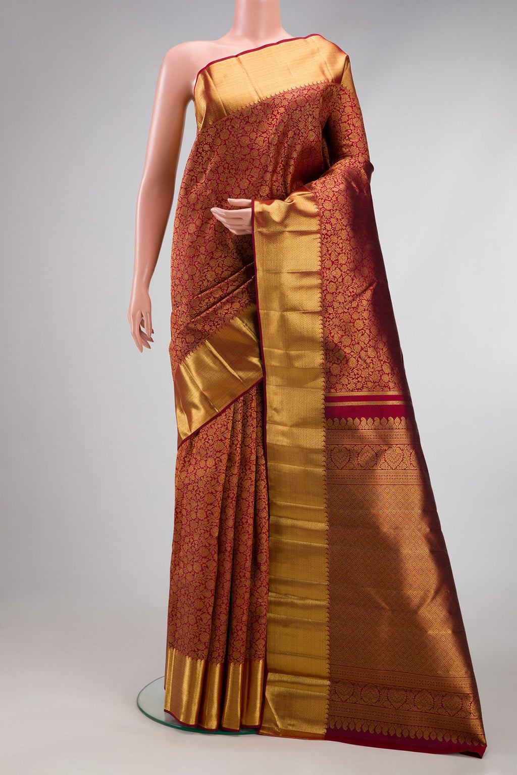 Pure Silk Pure Zari Maroon Kanjivaram Saree with Zari Brocade on the body and Zari Border.  displayed on a mannequin