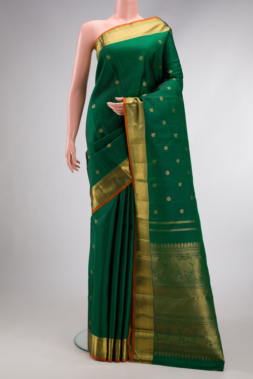 Pure Silk Pure Zari Green Dual Tone Kanjivaram Saree with Zari Butta on the body and Zari Border.  displayed on a mannequin
