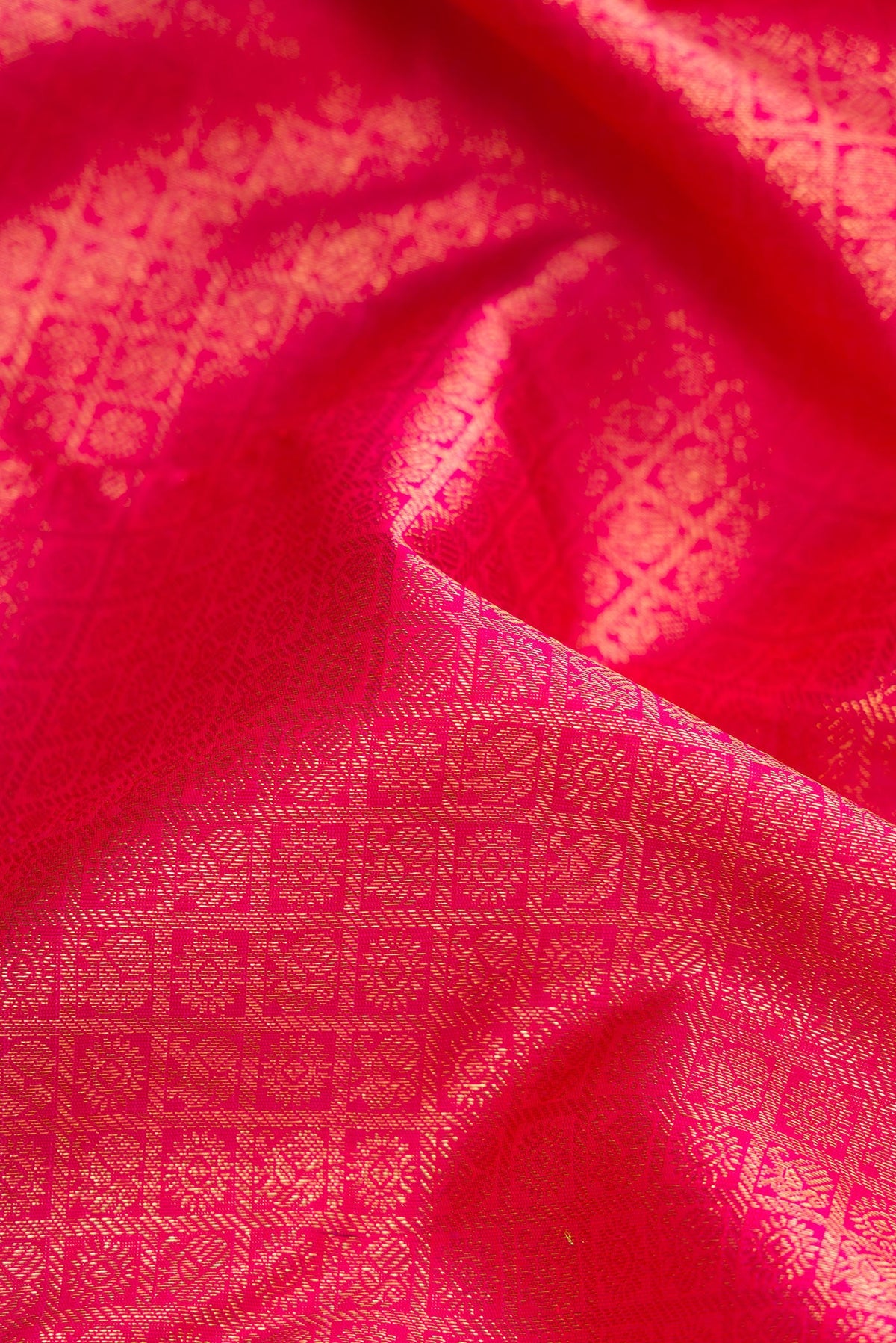 Close up of Pure Silk Pure Zari Pink Dual Tone Kanjivaram Saree with Zari Brocade on the body and Zari Border.  displaying folds