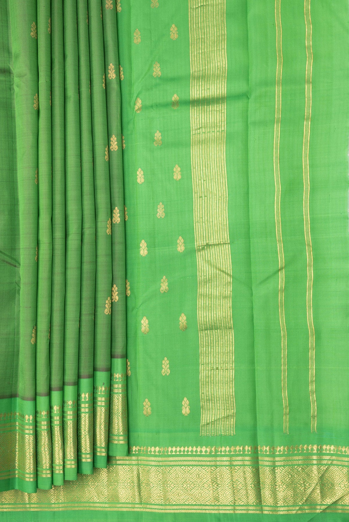 Pleats and pallu of Green Kanjivaram Silk Saree with Zari Butta on the body and One Side Border. 