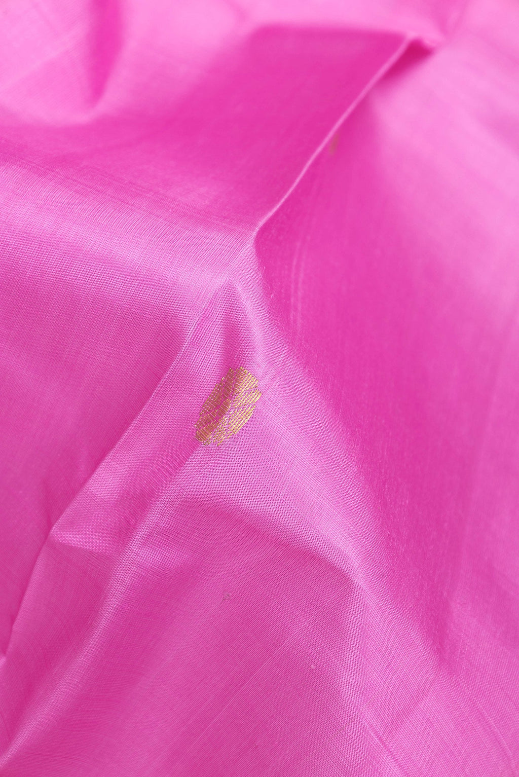 Close up of Pink Kanchipuram Silk Saree with Zari Butta on the body and One Side Border.  displaying folds