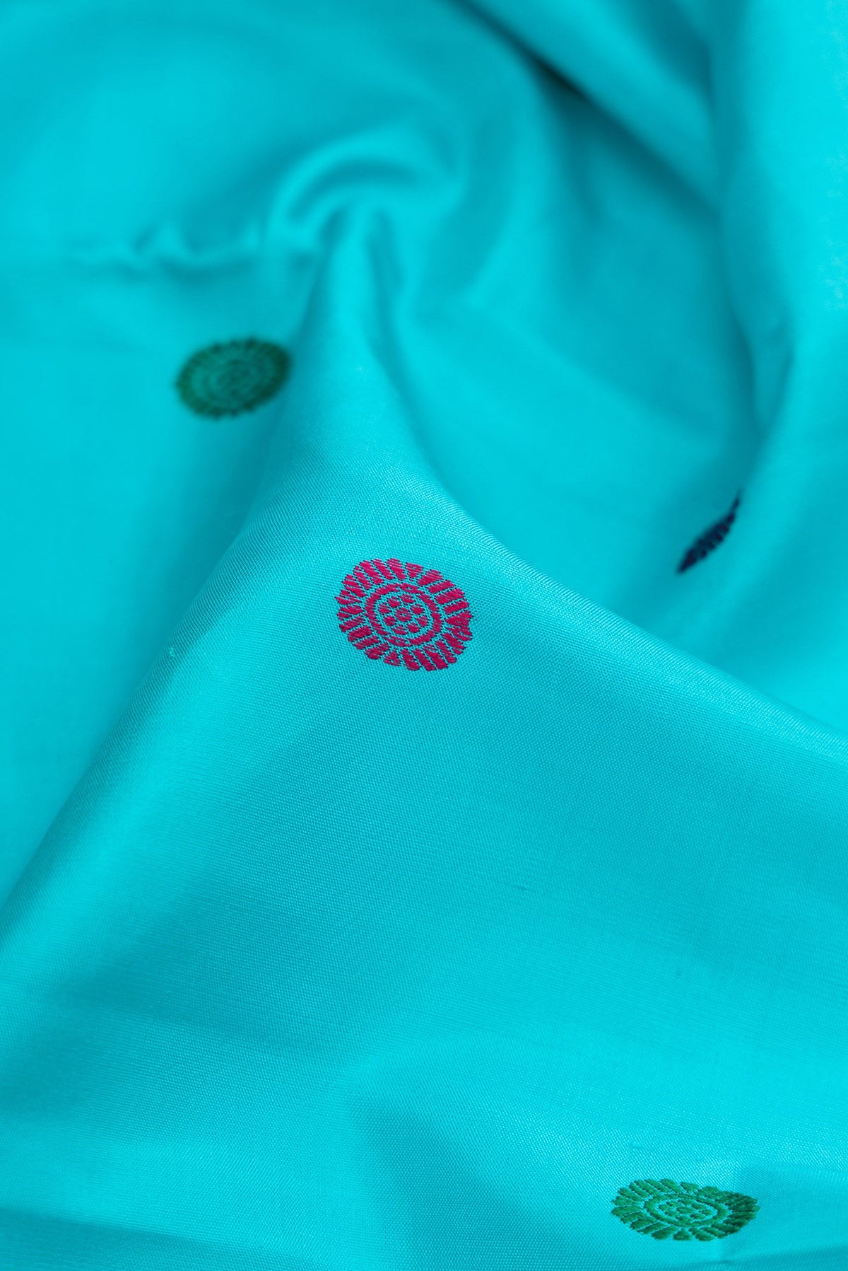Close up of Sky Blue Dual Tone Kanchipuram Silk Saree with Thread Butta on the body and Zari Border.  displaying folds
