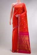 Coral Dual Tone Kanchipuram Silk Saree with Zari Butta on the body and Zari Border.  displayed on a mannequin