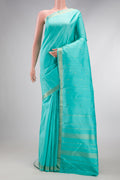 Sky Blue Dual Tone Kanchipuram Silk Saree with Zari Butta on the body and Zari Border.  displayed on a mannequin