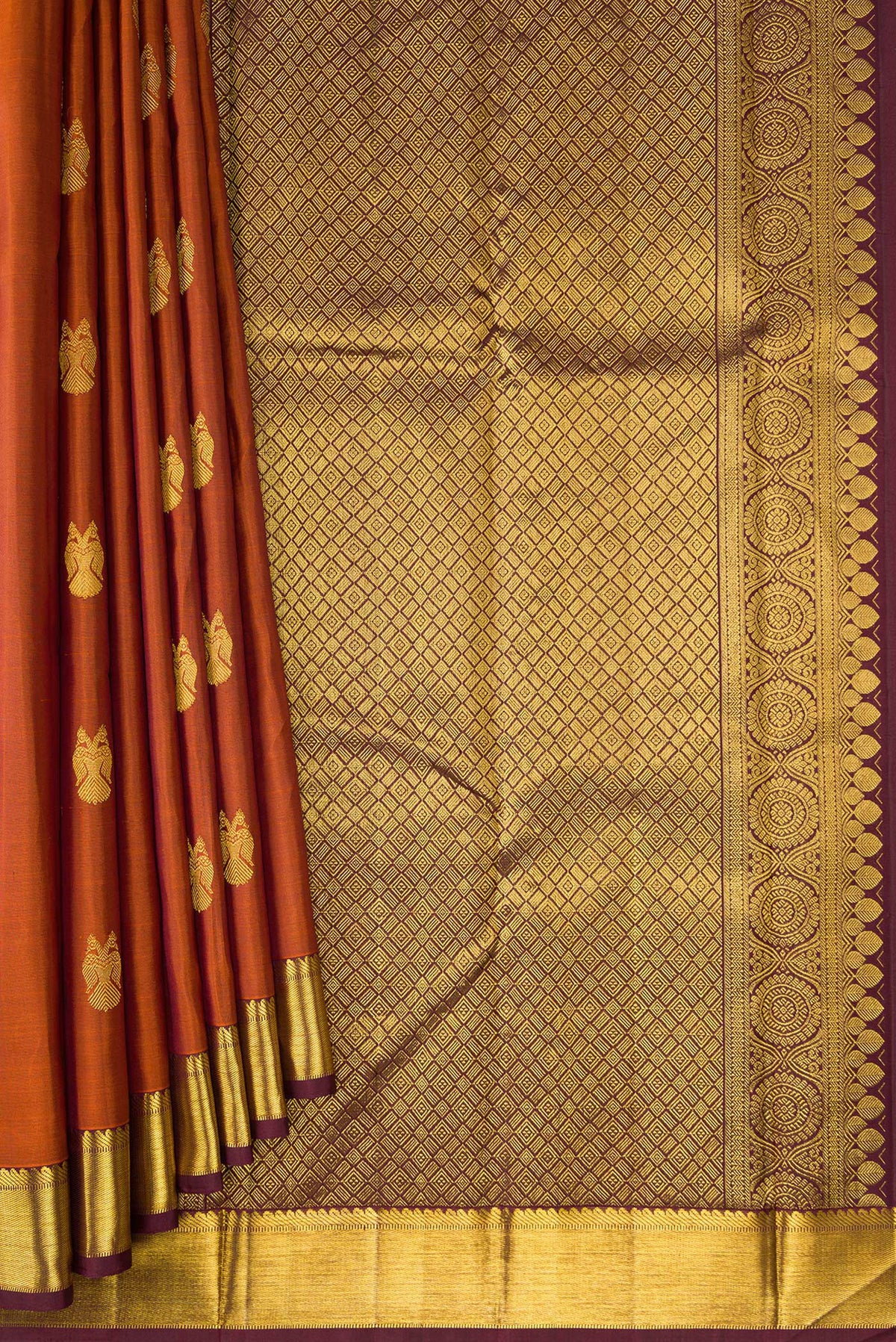 Pleats and pallu of Brick Orange Dual Tone Kanjivaram Silk Saree with Zari Butta on the body and Zari Border. 