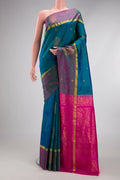 Peacock Blue Dual Tone Soft Silk Saree with Zari Butta on the body and Fancy Border.  displayed on a mannequin
