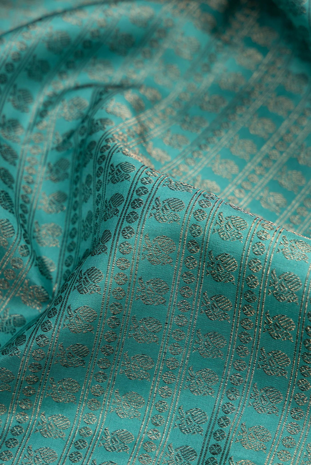 Close up of Maya Blue Kanjivaram Silk Saree with Jacquard design on the body and Fancy Border.  displaying folds