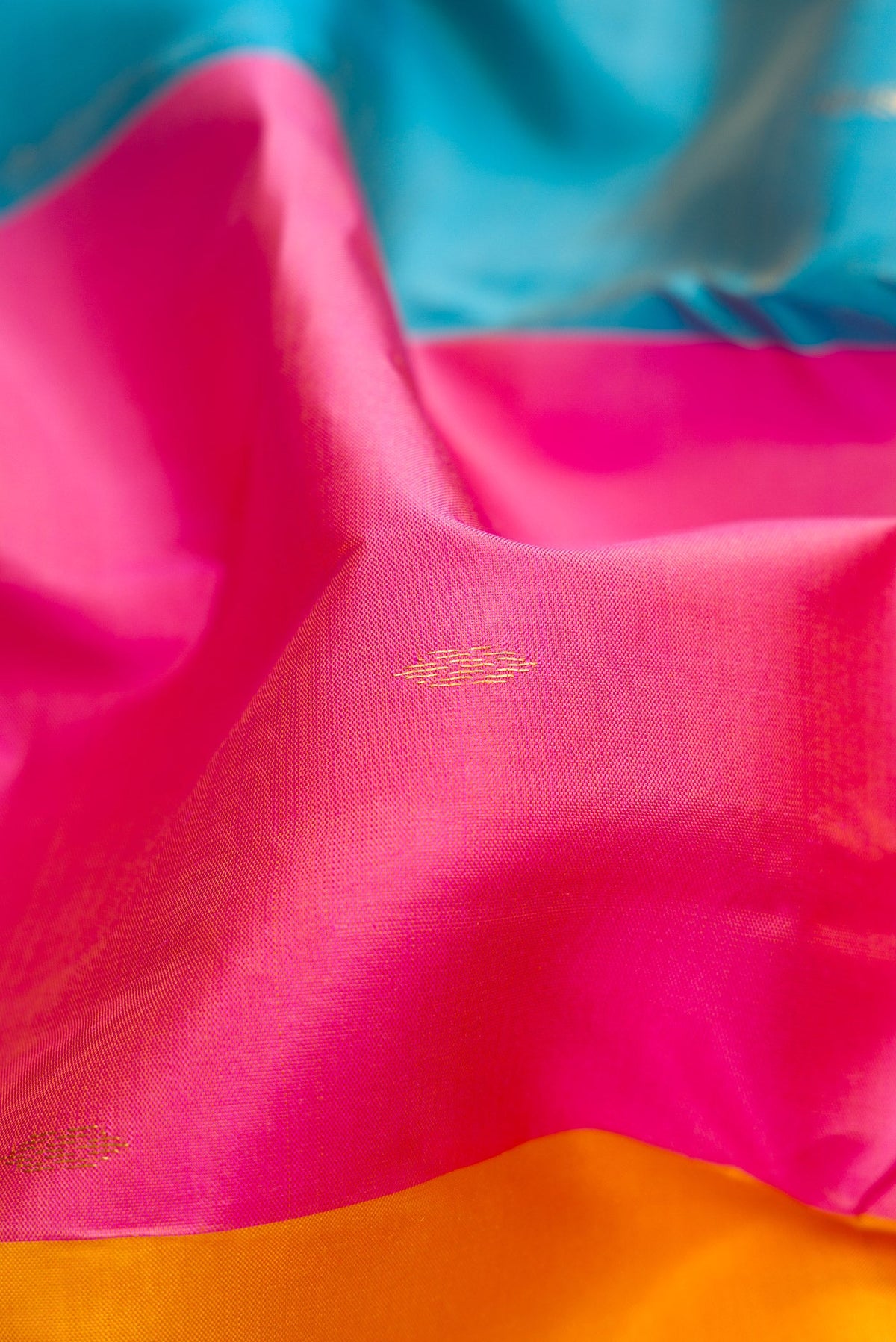 Close up of Multi Color Kanchipuram Silk Saree with Zari Butta on the body and Zari Border.  displaying folds