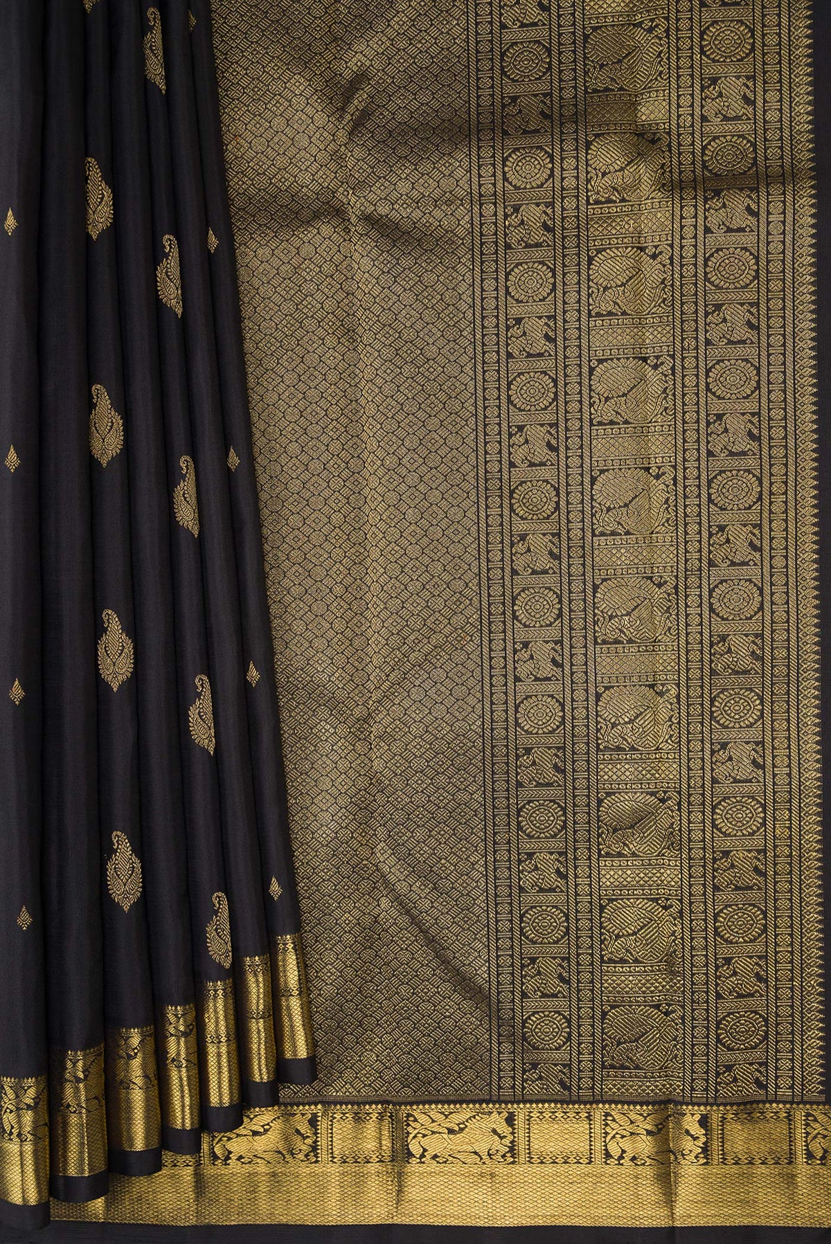 Pleats and pallu of Black Kanchipuram Silk Saree with Zari Butta on the body and Zari Border. 