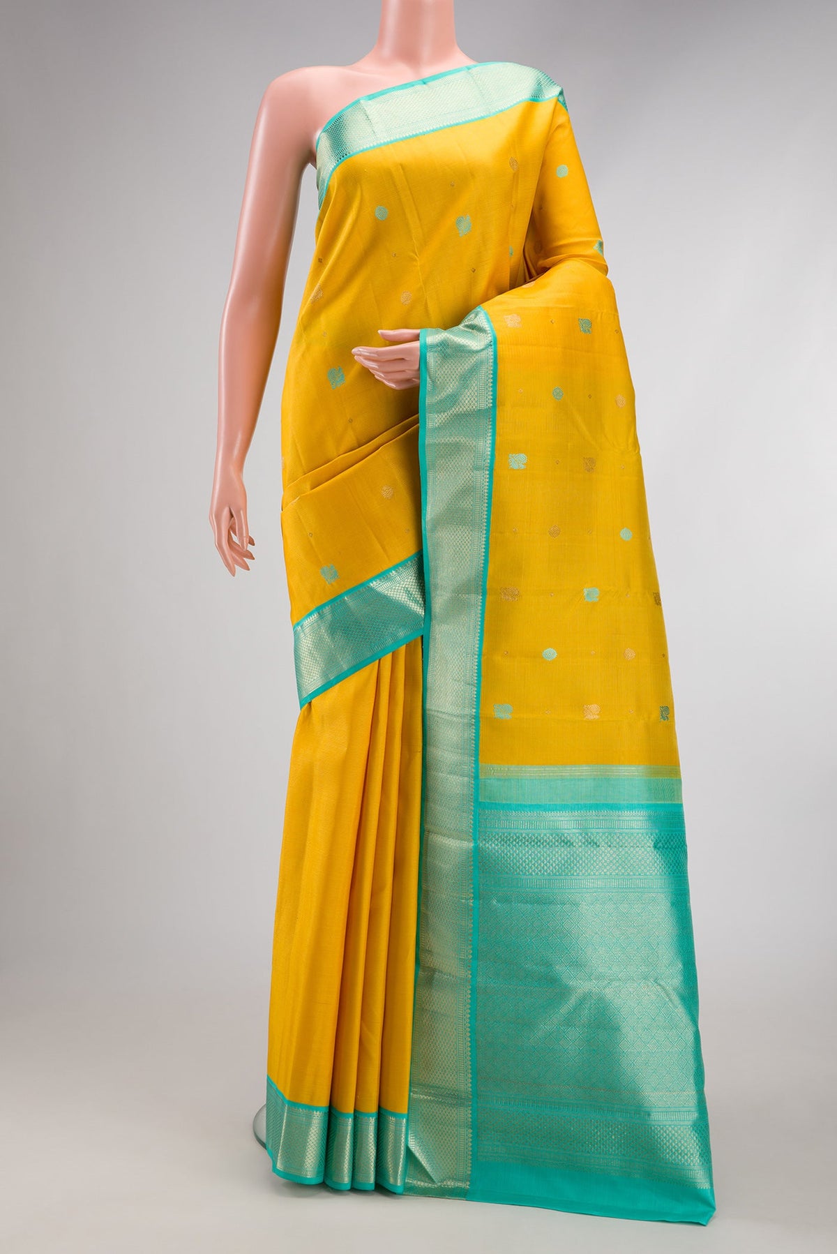 Pure Silk Pure Zari Yellow Kanchipuram Saree with Thread Butta on the body and Zari Border.  displayed on a mannequin