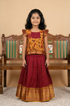 Mustard Readymade Cotton Pavadai Set with Zari Butta on the body and Zari Border displayed on a mannequin