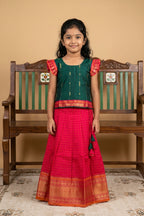 Green Readymade Cotton Pavadai Set with Zari Butta on the body and Zari Border displayed on a mannequin