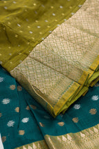 Detailed shot of Mehandi Green Readymade Cotton Pavadai Set with Zari Butta on the body and Zari Border