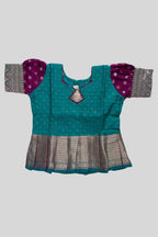 Close up blouse image of Green Readymade Cotton Pavadai Set with Zari Butta on the body and Zari Border