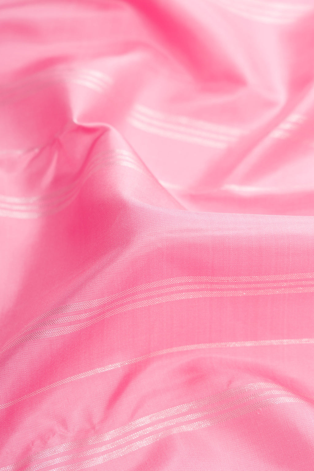 Close up of Pure Silk Pure Zari Pink Dual Tone Kanjivaram Saree with Stripes on the body and Fancy Border.  displaying folds