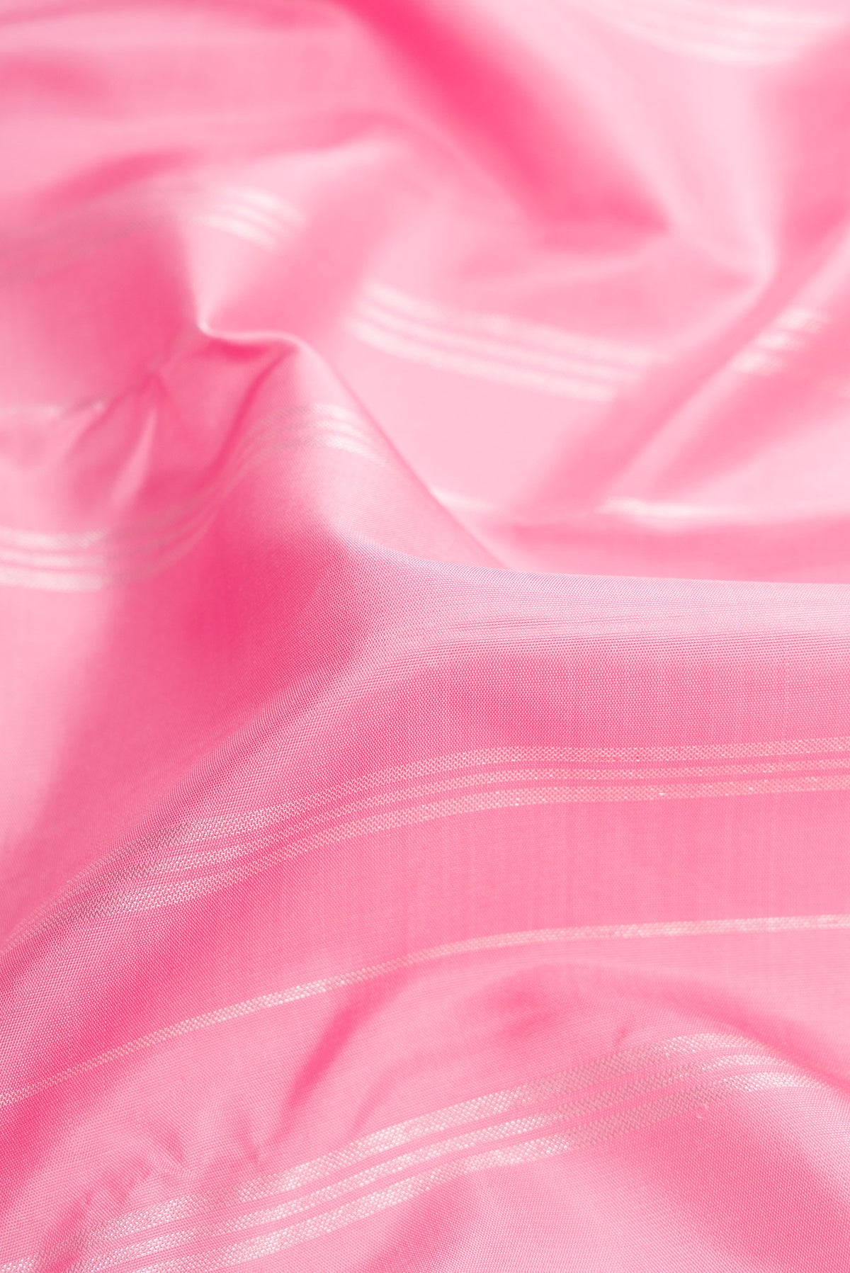Close up of Pure Silk Pure Zari Pink Dual Tone Kanjivaram Saree with Stripes on the body and Fancy Border.  displaying folds