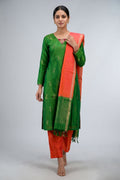 Green Pure Silk Womens Kurta set featuring Zari Butta Kurta paired with Orange Plain Body bottom and a Zari Butta dupatta in Orange front image displayed on an AI model