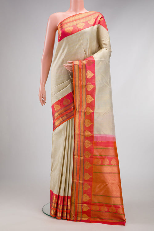 Beige Dual Tone Kanchipuram Silk Saree with Stripes on the body and Fancy Border.  displayed on a mannequin