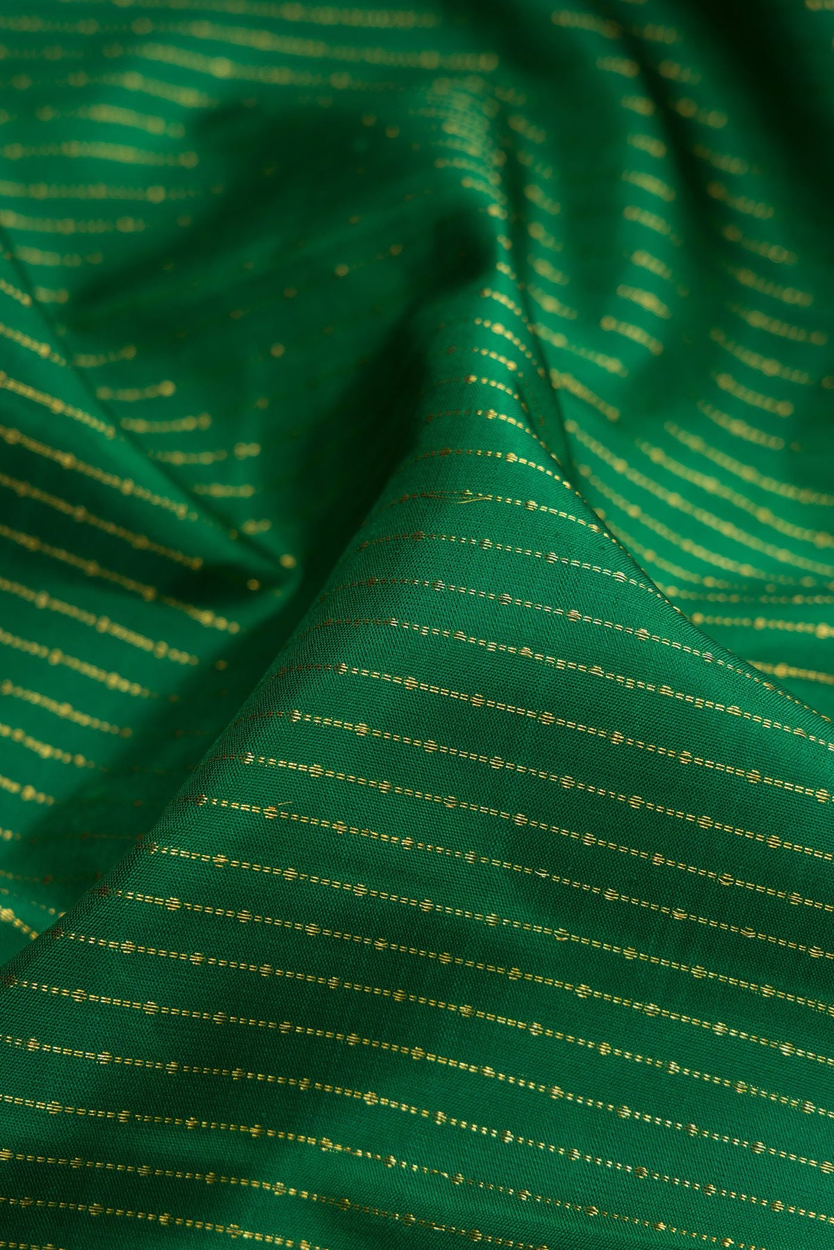 Close up of Bottle Green Kanchipuram Silk Saree with Stripes on the body and Zari Border.  displaying folds
