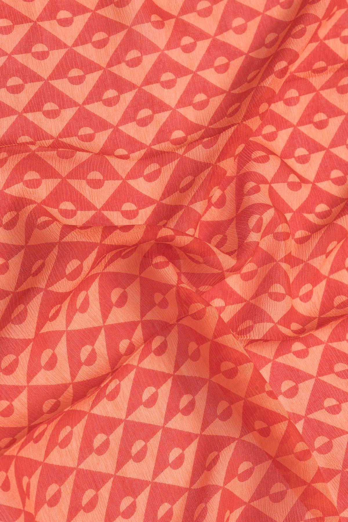 Close up of Red Dual Tone Mysore Chiffon Saree with Printed design on the body and Checks Border.  displaying folds