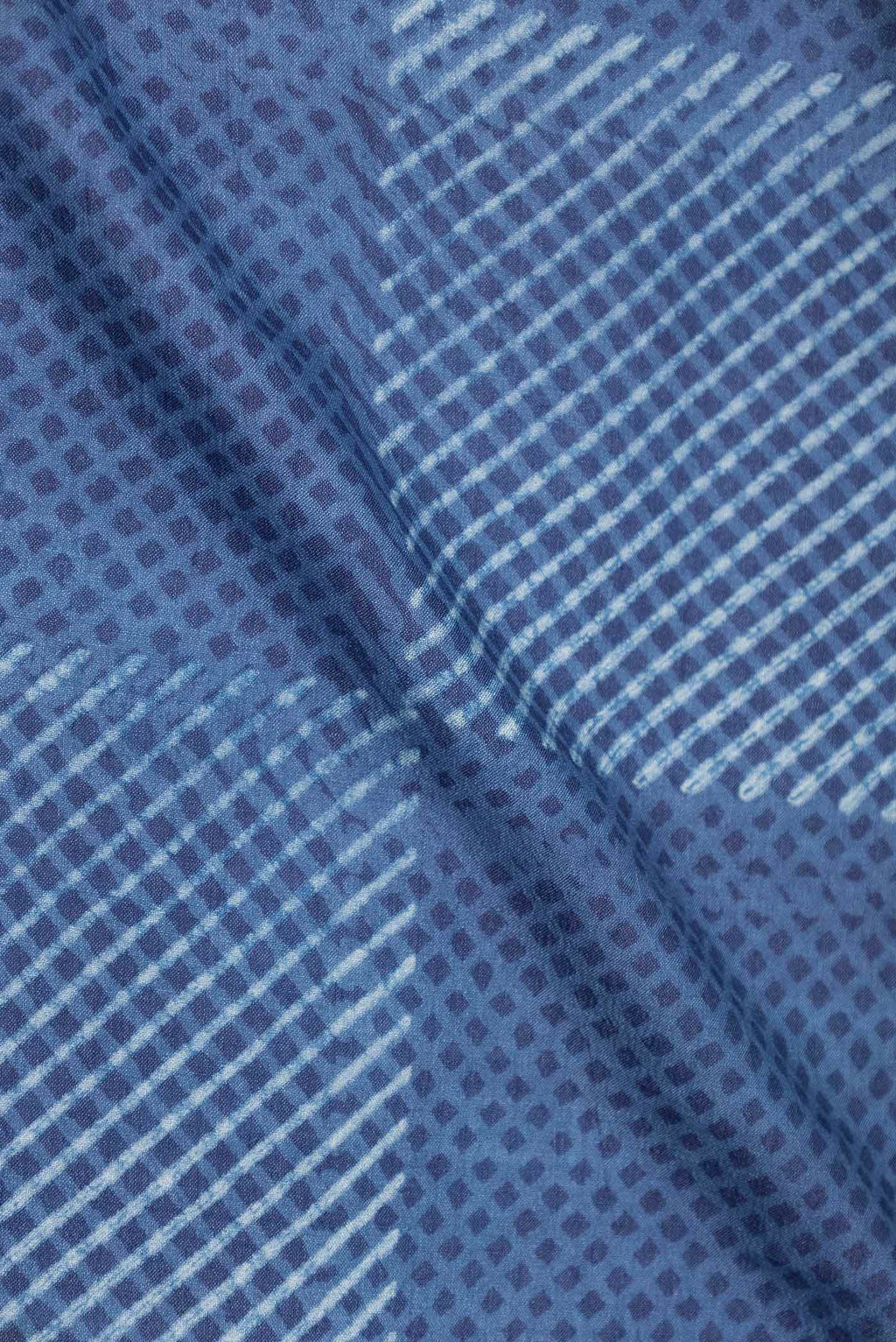 Close up of Blue Dual Tone Tussar Silk Saree with Printed design on the body and Printed Border displaying folds