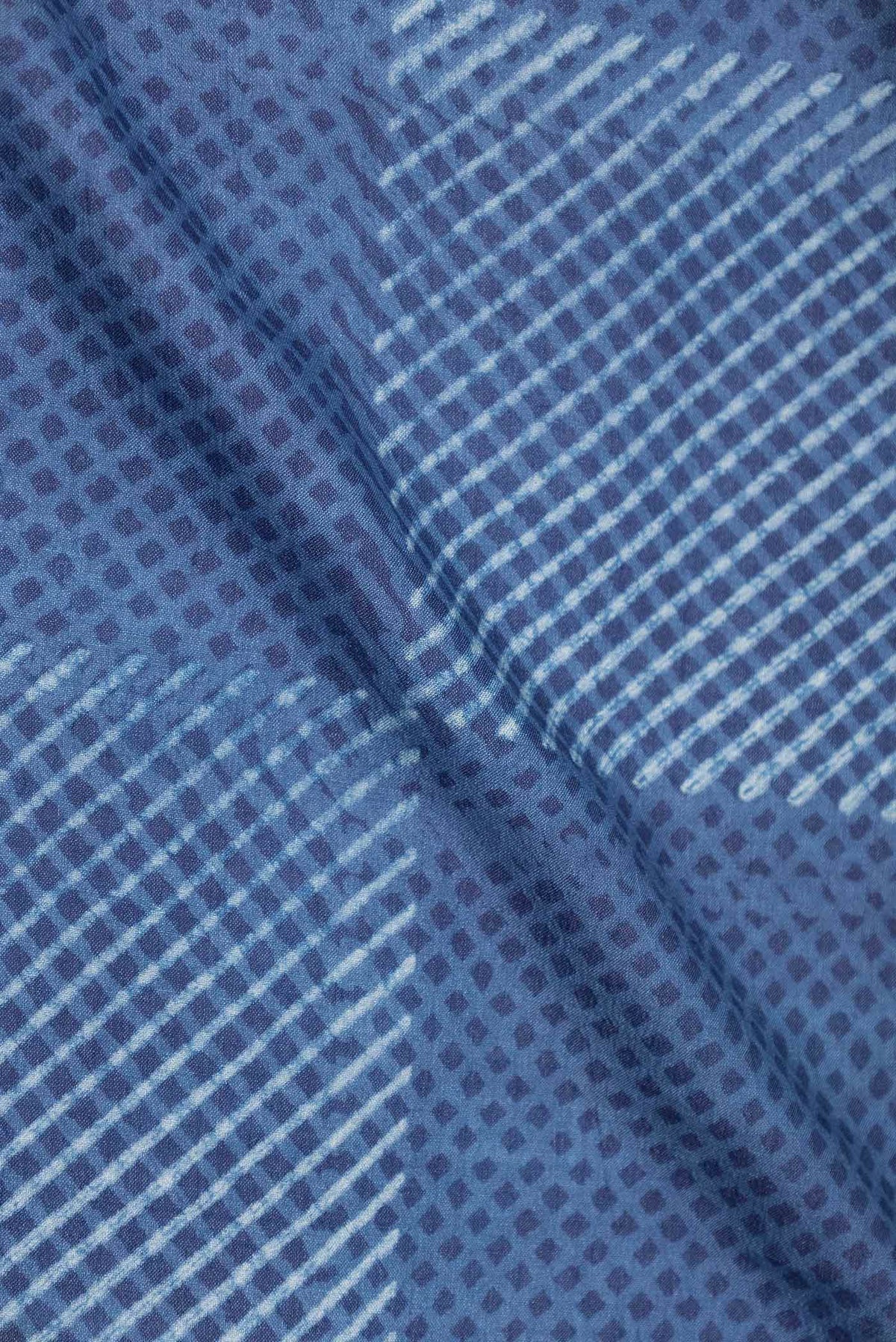 Close up of Blue Dual Tone Tussar Silk Saree with Printed design on the body and Printed Border displaying folds